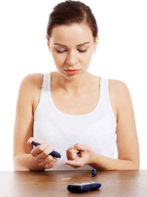 Beautiul young woman taking sugar level test. Beautiul young woman taking sugar level test. Isolated on white.
